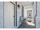 Charming front porch with whitewashed brick, a wooden floor, and seating for relaxing outdoors at 272 Coming St # C, Charleston, SC 29403