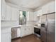 Updated kitchen featuring stainless steel appliances, white cabinets, and a bright window at 272 Coming St # C, Charleston, SC 29403