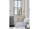 A clean kitchen with a stainless steel dishwasher and a view through the window out to the back at 272 Coming St # C, Charleston, SC 29403