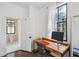 Home office with desk, a view to the neighborhood, and an attached bathroom at 272 Coming St # C, Charleston, SC 29403