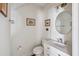 Well-lit half bathroom featuring a pedestal sink, modern fixtures, and decorative wall art at 272 Coming St # C, Charleston, SC 29403
