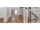 An interior shot of the staircase showcasing the bright hardwood floors and modern black and white banister at 272 Coming St # C, Charleston, SC 29403