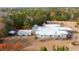 Aerial view of home with a light roof, outbuildings, and surrounding trees with fall colors at 280 Royalegates Ct, Cross, SC 29436