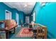 Hallway with turquoise painted walls leading to multiple rooms and featuring a red and black patterned rug at 280 Royalegates Ct, Cross, SC 29436