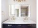 Modern bathroom with double vanity, illuminated mirror, and stylish fixtures at 2836 Edenborough Rd, Johns Island, SC 29455