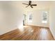 Bright bedroom featuring wood-look floors, ceiling fan and two windows at 2836 Edenborough Rd, Johns Island, SC 29455