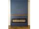 Living room fireplace with blue shiplap surround, modern linear firebox, and wood mantle at 2836 Edenborough Rd, Johns Island, SC 29455