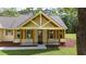Inviting front porch with timber columns and wood-stained front door at 2836 Edenborough Rd, Johns Island, SC 29455