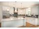 Bright kitchen with white cabinets, stainless steel appliances, and a large island at 2836 Edenborough Rd, Johns Island, SC 29455
