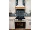 Close-up of a modern kitchen featuring a stainless steel range and designer backsplash at 2836 Edenborough Rd, Johns Island, SC 29455
