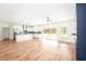 Open-concept living room and kitchen with wood floors, island, stainless appliances and sliding glass doors at 2836 Edenborough Rd, Johns Island, SC 29455