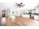 Bright living room with wood-look flooring, white walls, open to the kitchen, and a striking wood front door at 2836 Edenborough Rd, Johns Island, SC 29455