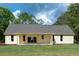 View of the rear exterior with a covered patio and well-maintained lawn at 2836 Edenborough Rd, Johns Island, SC 29455