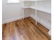 A white storage area with open shelves and wood-look flooring at 2836 Edenborough Rd, Johns Island, SC 29455