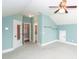 Large bedroom with vaulted ceilings, a fan, light blue walls, and multiple access and storage areas at 287 Commonwealth Rd, Mount Pleasant, SC 29466