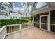 View of the wood deck, the screen porch, and the manicured lawn and landscaping surrounding the property at 287 Commonwealth Rd, Mount Pleasant, SC 29466
