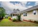 Exterior shot of the single Gathering home with a view of the screened in porch and manicured front lawn at 287 Commonwealth Rd, Mount Pleasant, SC 29466
