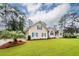 Low angle front exterior view of the house with the manicured front lawn at 287 Commonwealth Rd, Mount Pleasant, SC 29466