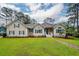Charming single-Gathering home with a well-manicured lawn and blue shutters at 287 Commonwealth Rd, Mount Pleasant, SC 29466