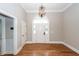 Bright foyer showcasing hardwood floors and an elegant chandelier at 287 Commonwealth Rd, Mount Pleasant, SC 29466