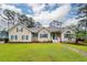 Charming one-story home featuring a spacious front yard with lush green grass and a brick walkway at 287 Commonwealth Rd, Mount Pleasant, SC 29466