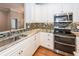 Close up on a kitchen with stainless appliances, tile backsplash, and stone countertops at 287 Commonwealth Rd, Mount Pleasant, SC 29466