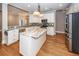 Bright kitchen with an island, stainless steel refrigerator, oven, and white cabinetry at 287 Commonwealth Rd, Mount Pleasant, SC 29466