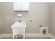 Laundry room featuring a utility sink, white cabinets, and neutral colored walls at 287 Commonwealth Rd, Mount Pleasant, SC 29466