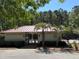 Community pool house featuring a red roof, gated entrance and palm trees at 287 Commonwealth Rd, Mount Pleasant, SC 29466