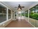 Inviting screened-in porch with wood flooring, ceiling fan and a view of a lush outdoor setting at 287 Commonwealth Rd, Mount Pleasant, SC 29466