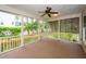 Screened-in porch with ceiling fan overlooking a beautifully landscaped yard and a well-maintained fence at 287 Commonwealth Rd, Mount Pleasant, SC 29466