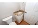 Elegant powder room featuring granite counters and hardwood floors at 287 Commonwealth Rd, Mount Pleasant, SC 29466