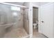 Walk-in shower with a glass door, river rock floor, and tile walls at 287 Commonwealth Rd, Mount Pleasant, SC 29466