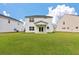 Home's back exterior with a well-manicured lawn and charming covered patio for relaxing outdoors at 296 Torslanda Ln, Summerville, SC 29486
