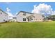 Expansive backyard featuring a well-maintained lawn and a covered patio, perfect for outdoor entertaining at 296 Torslanda Ln, Summerville, SC 29486