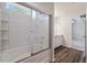 Bathroom showcasing a bathtub with a showerhead and glass doors, alongside a vanity with storage at 296 Torslanda Ln, Summerville, SC 29486