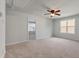 A bright bedroom with neutral walls, carpet flooring, a ceiling fan and doorway to another room at 296 Torslanda Ln, Summerville, SC 29486