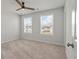 Bedroom with neutral carpet, a ceiling fan, and two large windows allowing plenty of natural light into the living space at 296 Torslanda Ln, Summerville, SC 29486