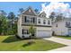 Charming two-story home with neutral siding, manicured lawn, and attached two car garage at 296 Torslanda Ln, Summerville, SC 29486