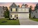 Charming two-story home with neutral siding, manicured lawn, and attached two car garage at 296 Torslanda Ln, Summerville, SC 29486