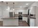 Modern kitchen features stainless steel appliances, a granite island, and ample cabinet space at 296 Torslanda Ln, Summerville, SC 29486