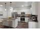 Stylish kitchen featuring stainless steel appliances, granite countertops, white cabinetry, and breakfast bar at 296 Torslanda Ln, Summerville, SC 29486