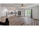 Open-concept kitchen with stainless steel appliances, white cabinets, island seating, and natural light from the window at 296 Torslanda Ln, Summerville, SC 29486