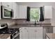 Bright kitchen with stainless steel appliances, granite countertops, and stylish dark hardware at 296 Torslanda Ln, Summerville, SC 29486