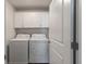 A dedicated laundry room with two machines and overhead cabinets at 296 Torslanda Ln, Summerville, SC 29486