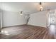 Bright, open living room with hardwood floors, ceiling fan, elegant lighting, and staircase to the upper level at 296 Torslanda Ln, Summerville, SC 29486