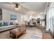 Open-concept living space with a cream sofa, dining area, and stainless steel appliances in the modern kitchen at 296 Torslanda Ln, Summerville, SC 29486