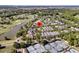 Aerial view showcases a home near a golf course, a pond, and tennis courts at 300 Ginned Cotton St, Charleston, SC 29492
