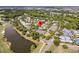 Aerial view of a property surrounded by lush landscaping, a pond, and a nearby golf course at 300 Ginned Cotton St, Charleston, SC 29492