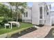 Grassy backyard with a white house in the background, featuring an outdoor dining area for relaxation and entertainment at 300 Ginned Cotton St, Charleston, SC 29492